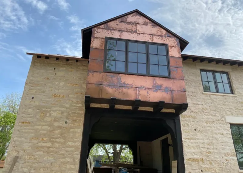 Copper metal panel facade on a stone building for Skylight Installation in Deer Park